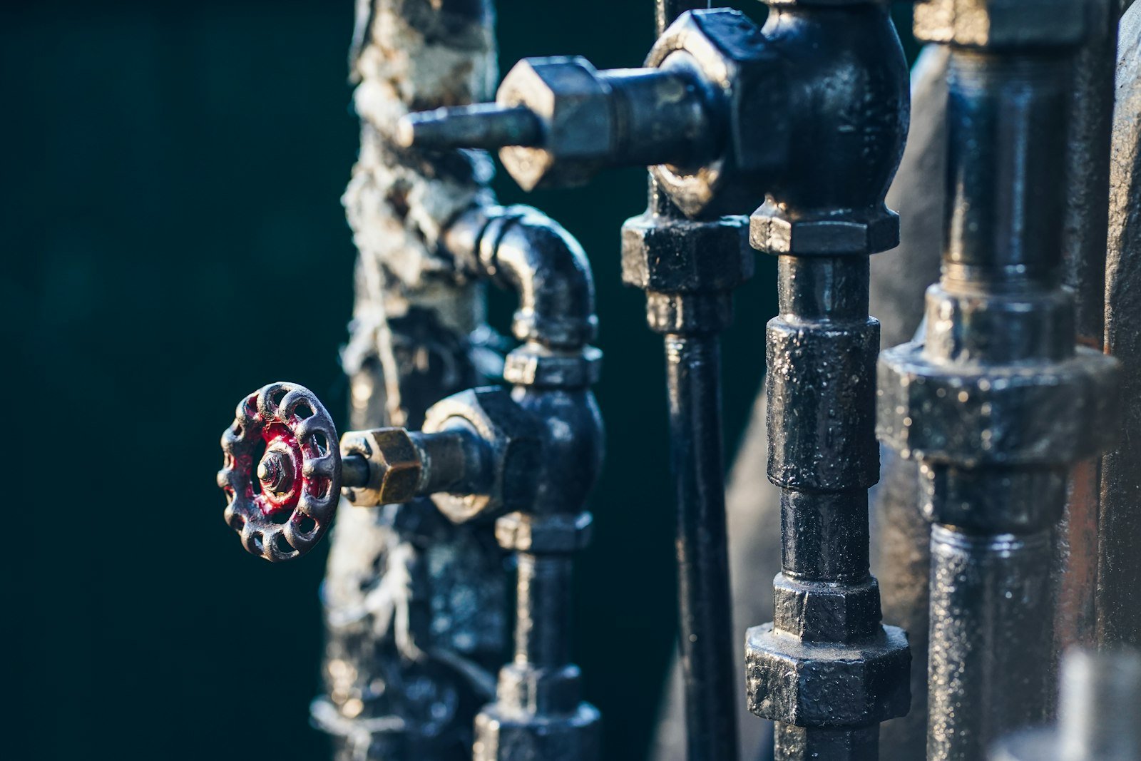 Blue pipework with a red valve wheel