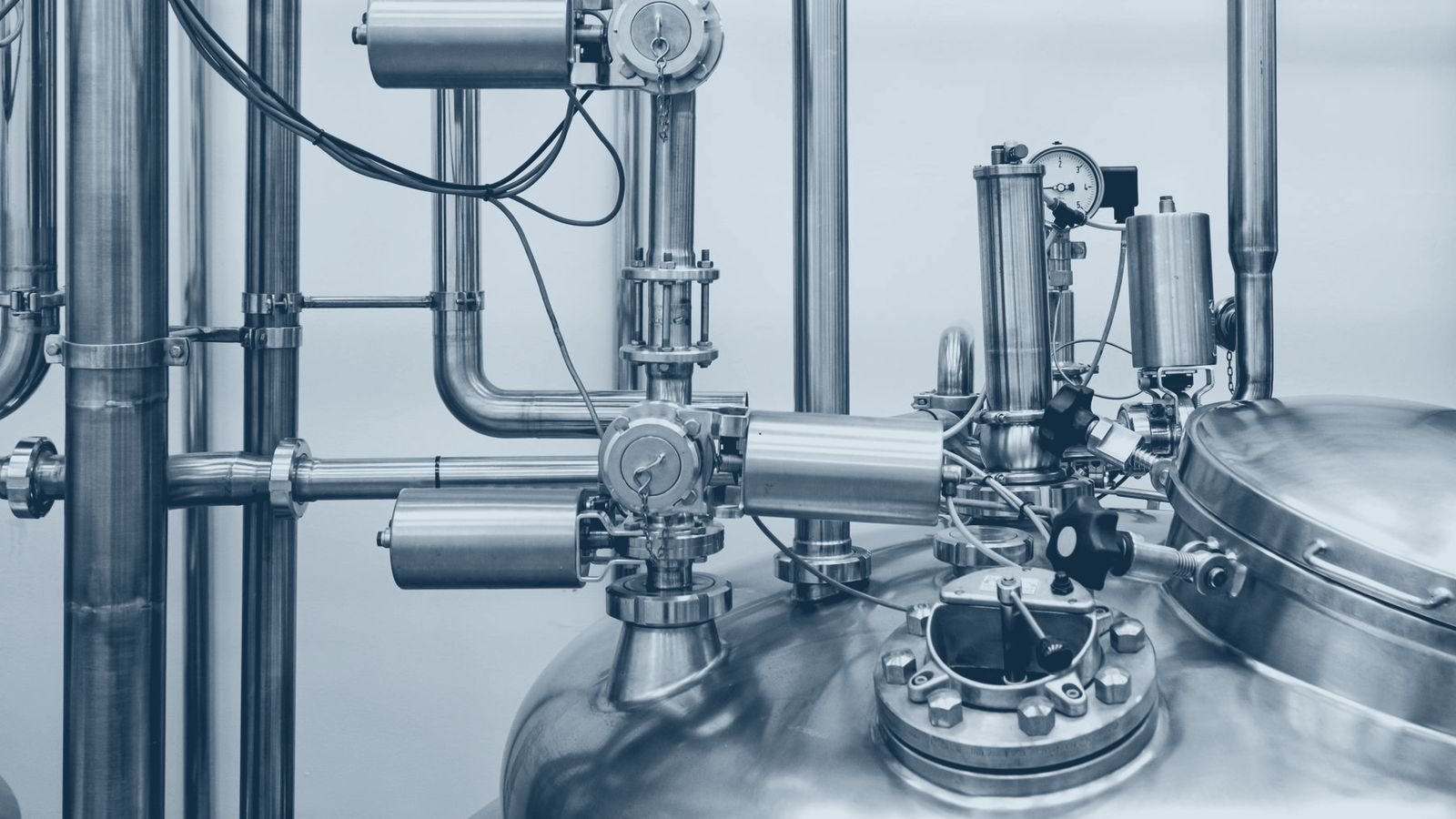 Stainless steel dairy process vessels and valve manifolds