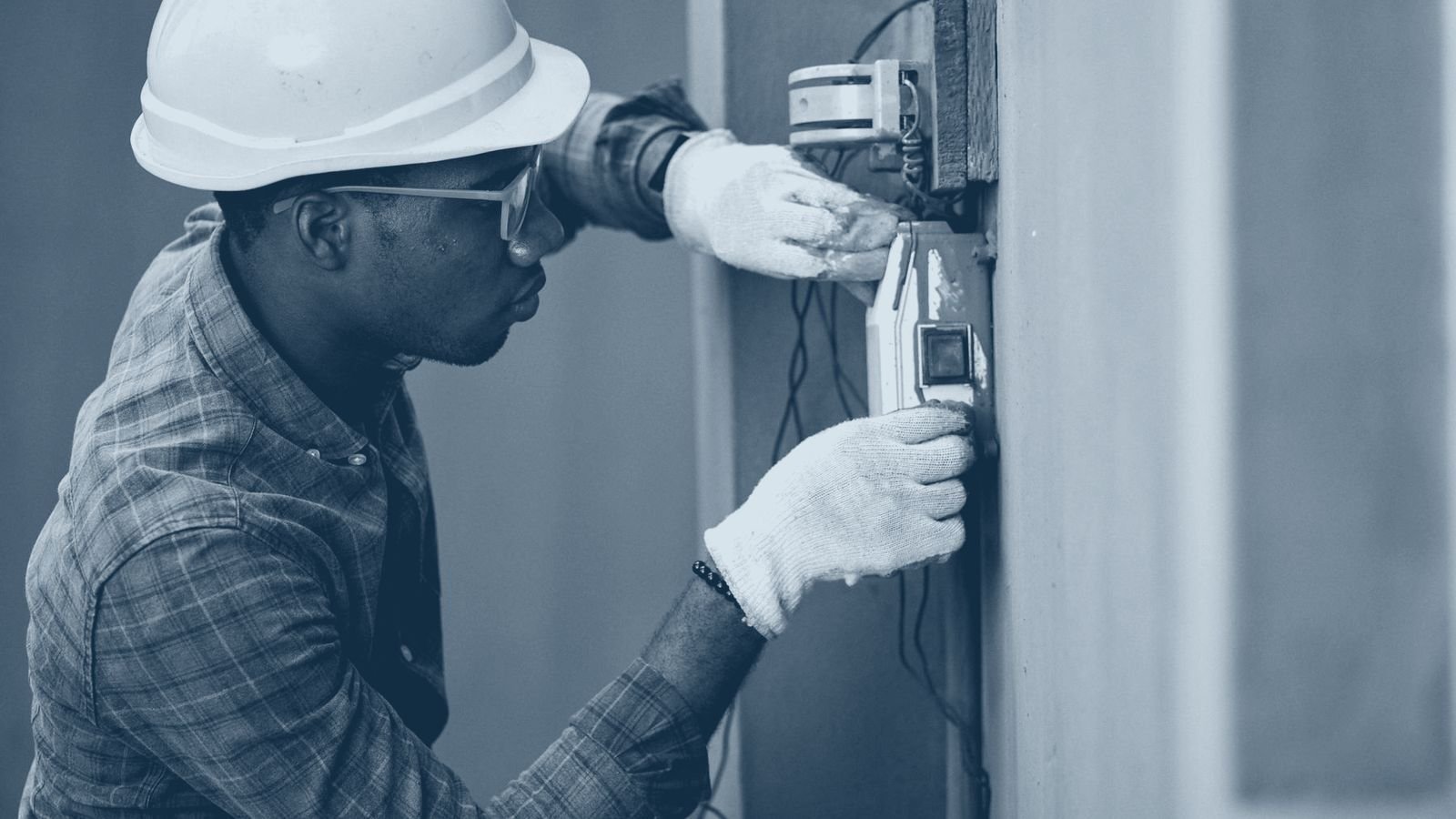 A technician servicing building electrical equipment