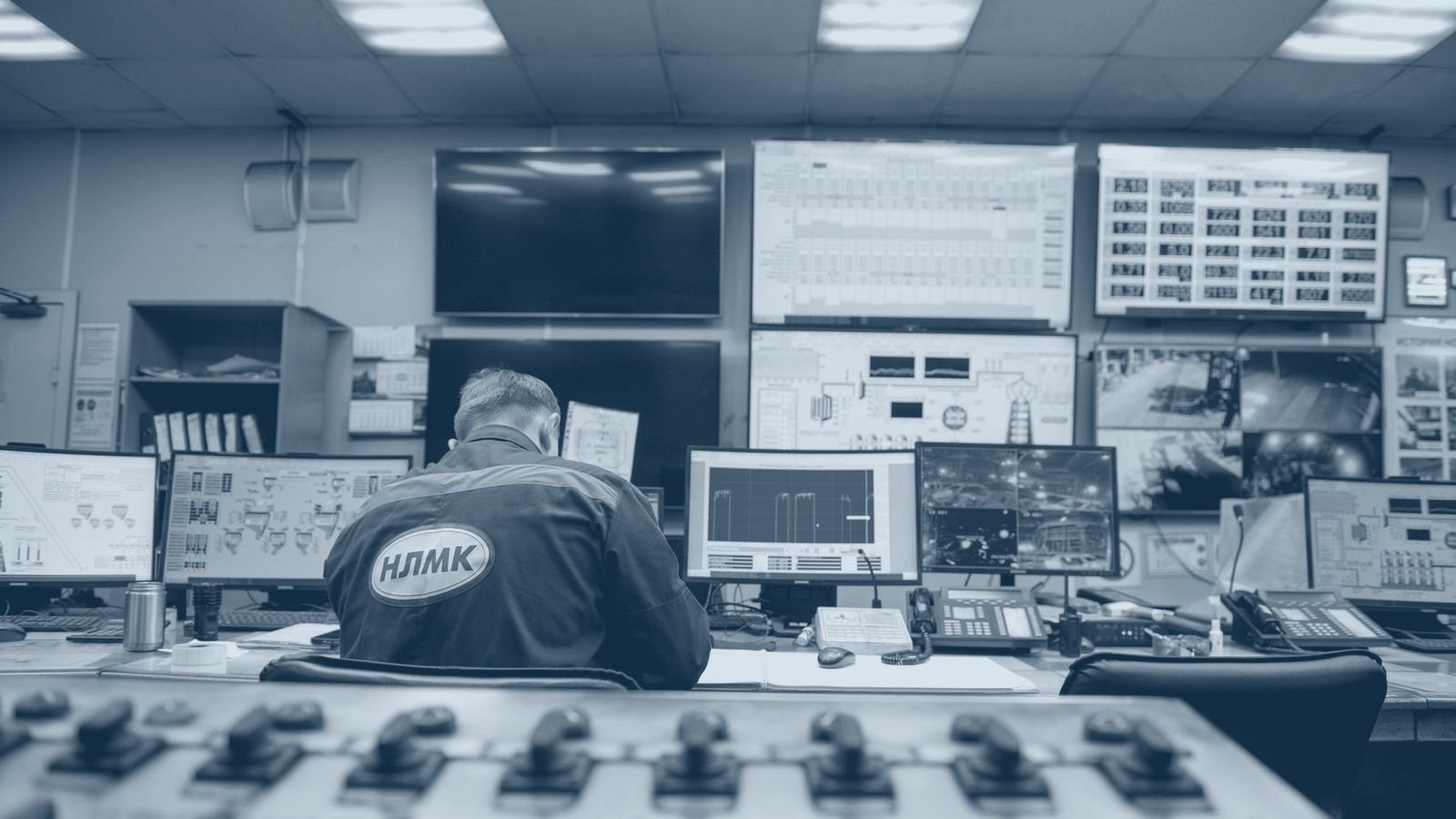 An engineer monitoring plant screens in an industrial control room