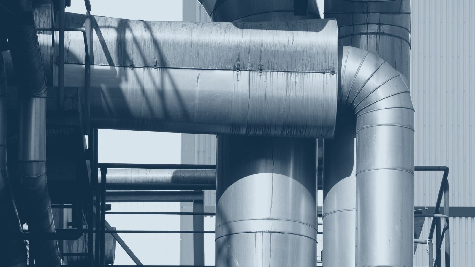 A dense network of stainless steel process pipes